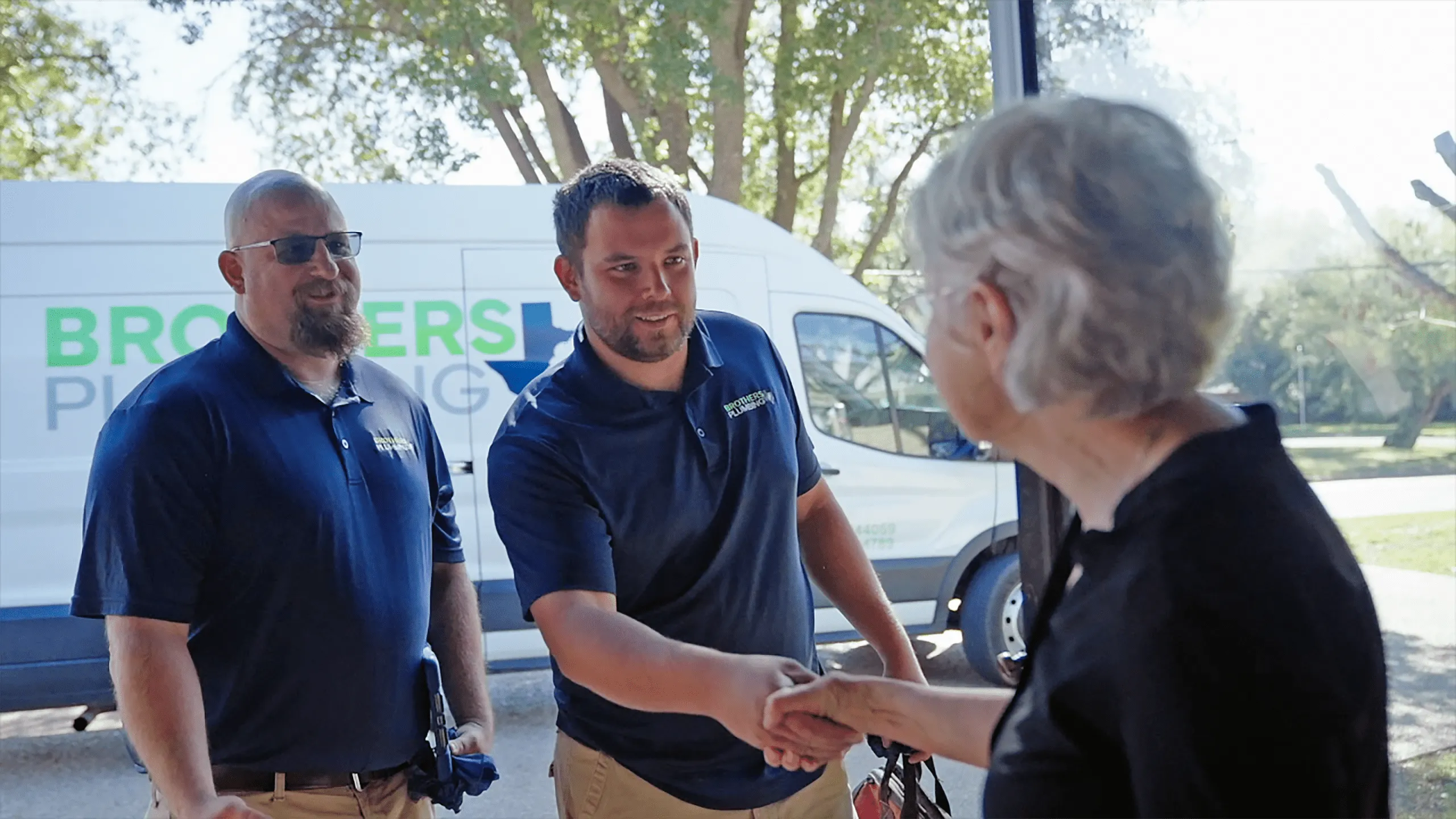 Brothers Plumbing technician shaking hands with an Abilene customer