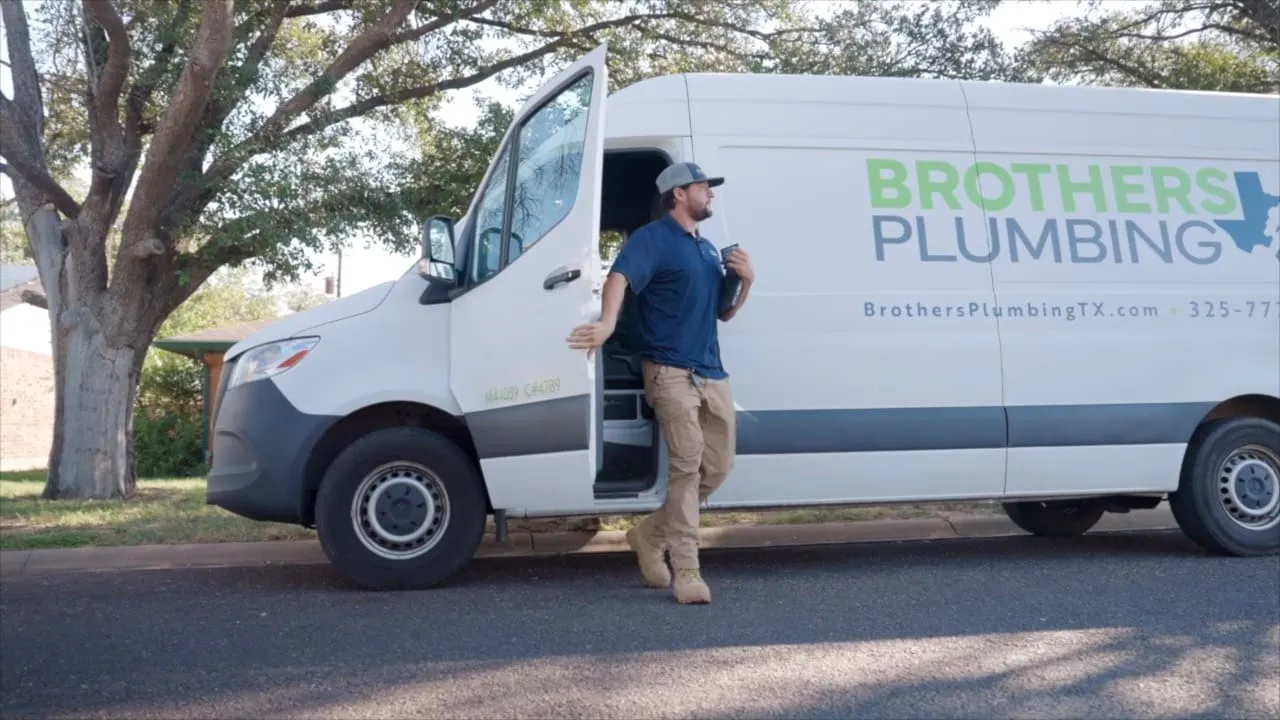 Brothers Plumbing technician stepping out of a service van for a water heater call in Abilene, TX