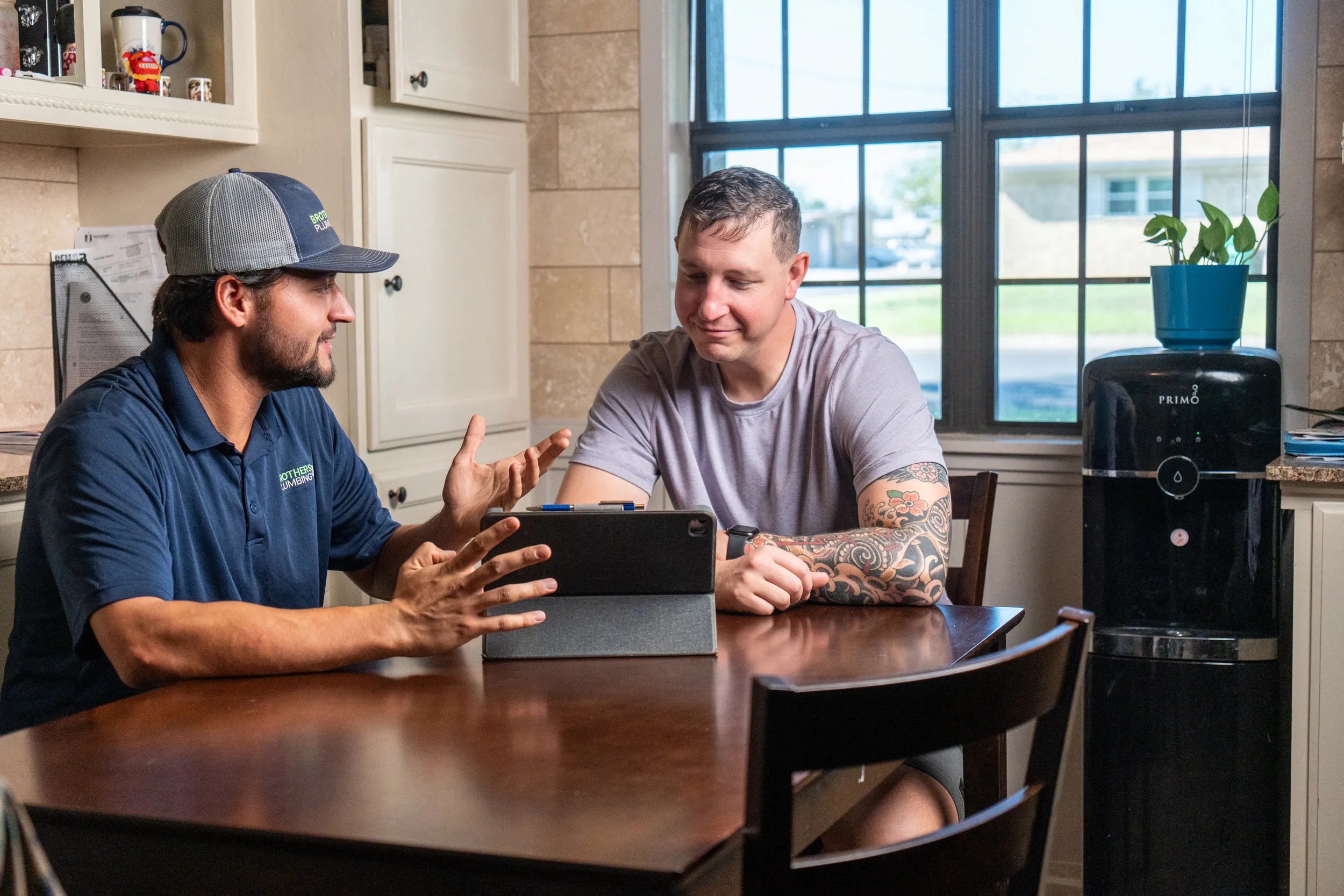 Brothers Plumbing technician reviewing options with a customer