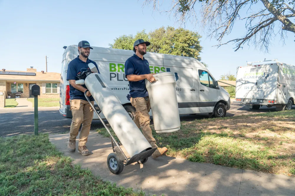 Brothers Plumbing technicians delivering a water filtration system in San Angelo & Abilene, TX